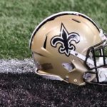 New Orleans Saints helmet sitting on grass